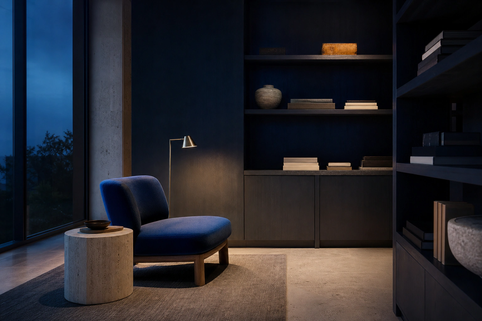 A cobalt reading chair and warm lamp in a quiet blue-hour library